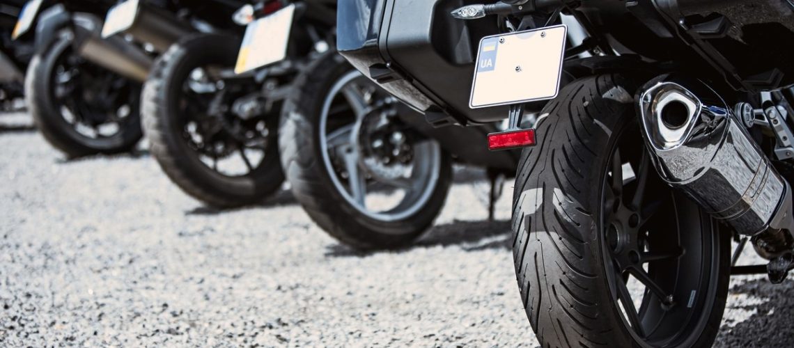 Motorcycle luxury items close-up: headlights, shock absorber, wheel, wing, toning. Concept travel on two wheels